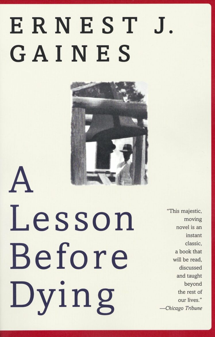 Cover of the book "A Lesson Before Dying" by Ernest J. Gaines. The cover features the title and author's name in bold letters, along with a small black-and-white photograph of a person standing outside a window and a quote from the Chicago Tribune.